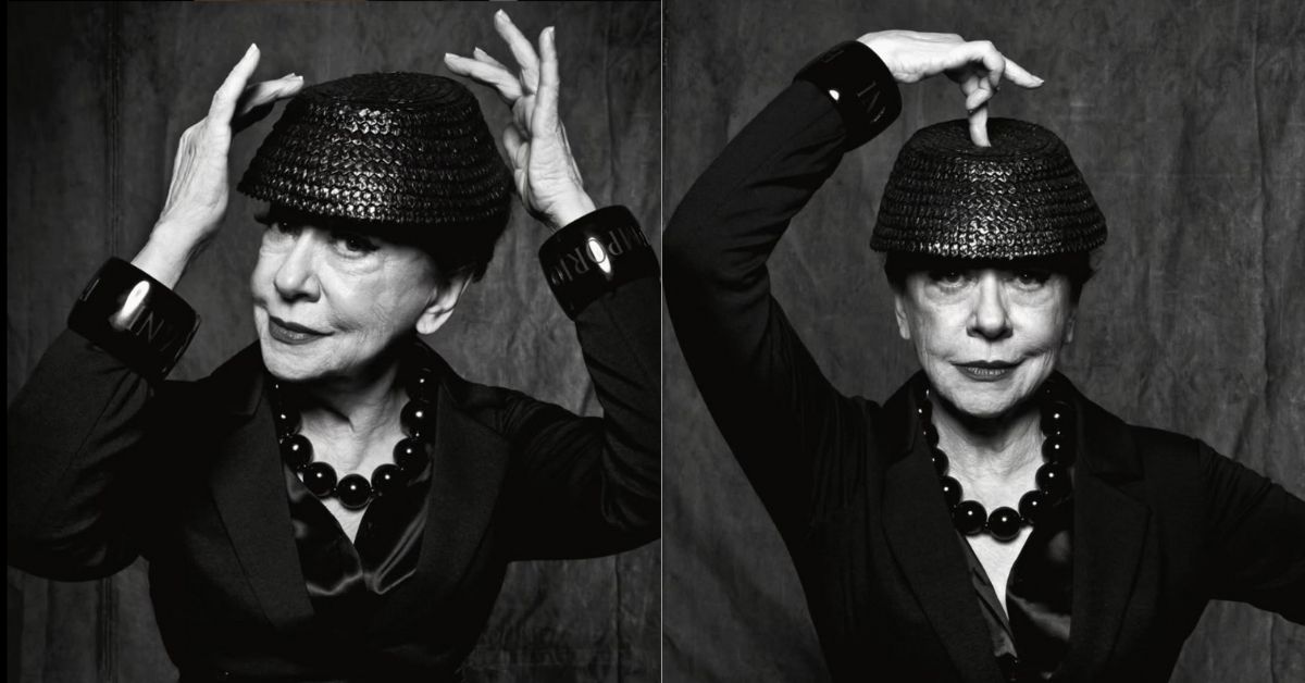 Fernanda Montenegro posa com elegância aos 96 anos, usando chapéu preto e colar de contas.