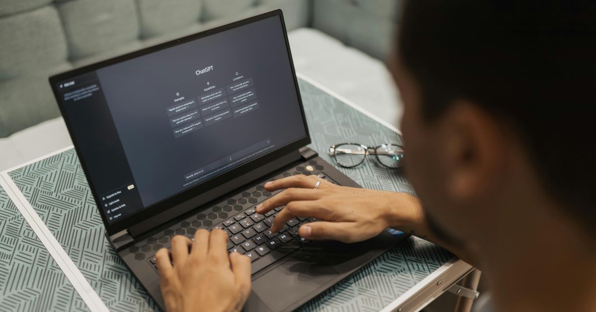 Pessoa utilizando inteligência artificial nas empresas em um notebook para aprimorar processos